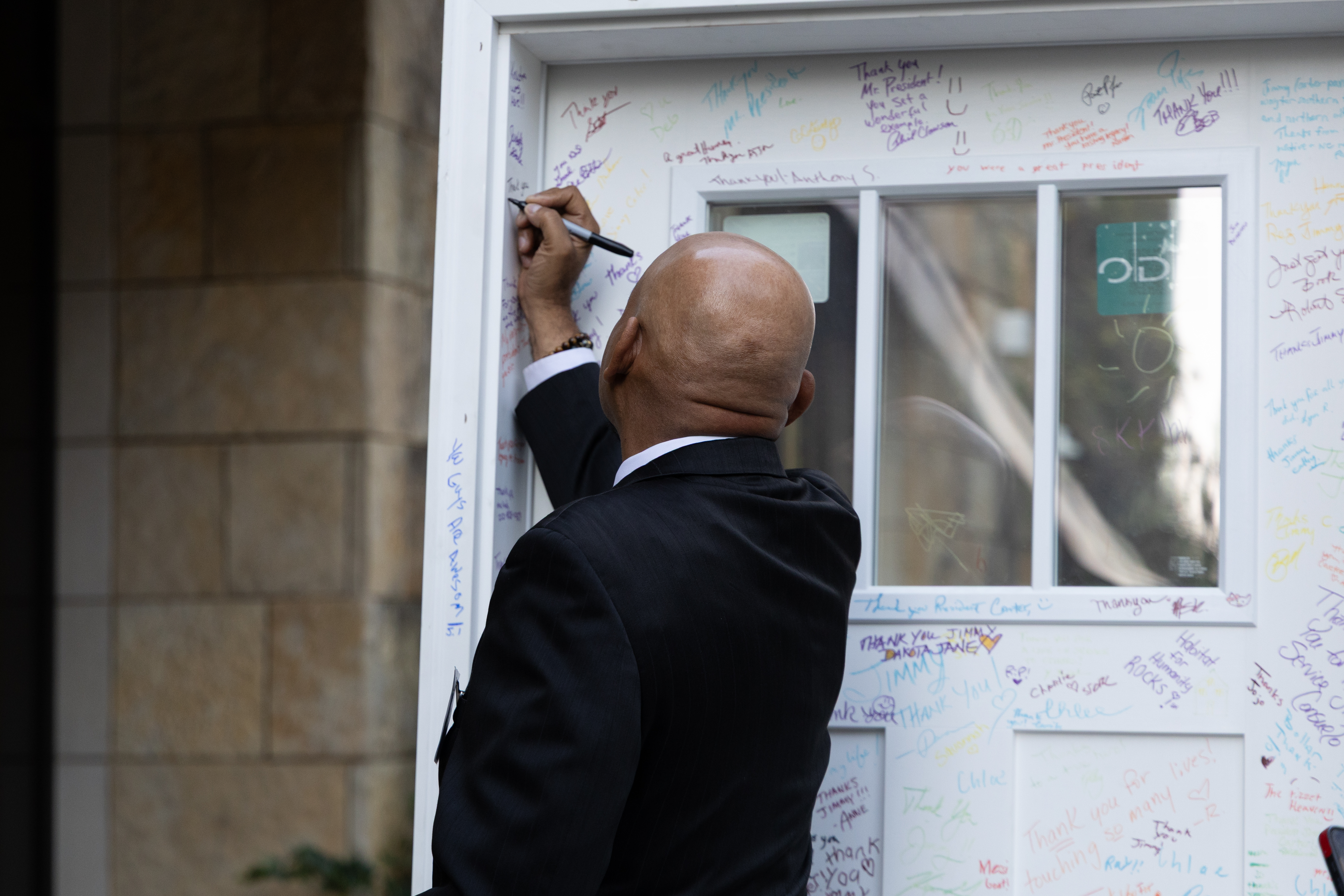 Community member signs Jimmy Carter legacy door at Habitat Wake's 40th Anniversary Gala