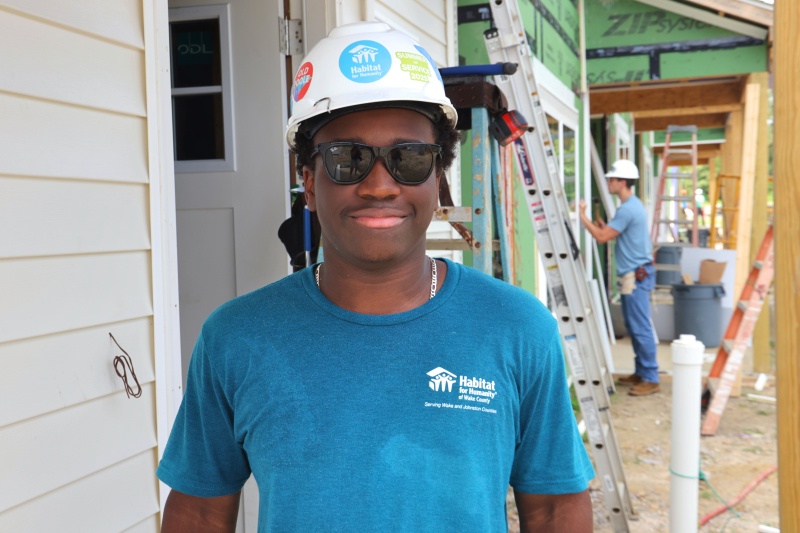 Summer of Service student volunteer at the job site