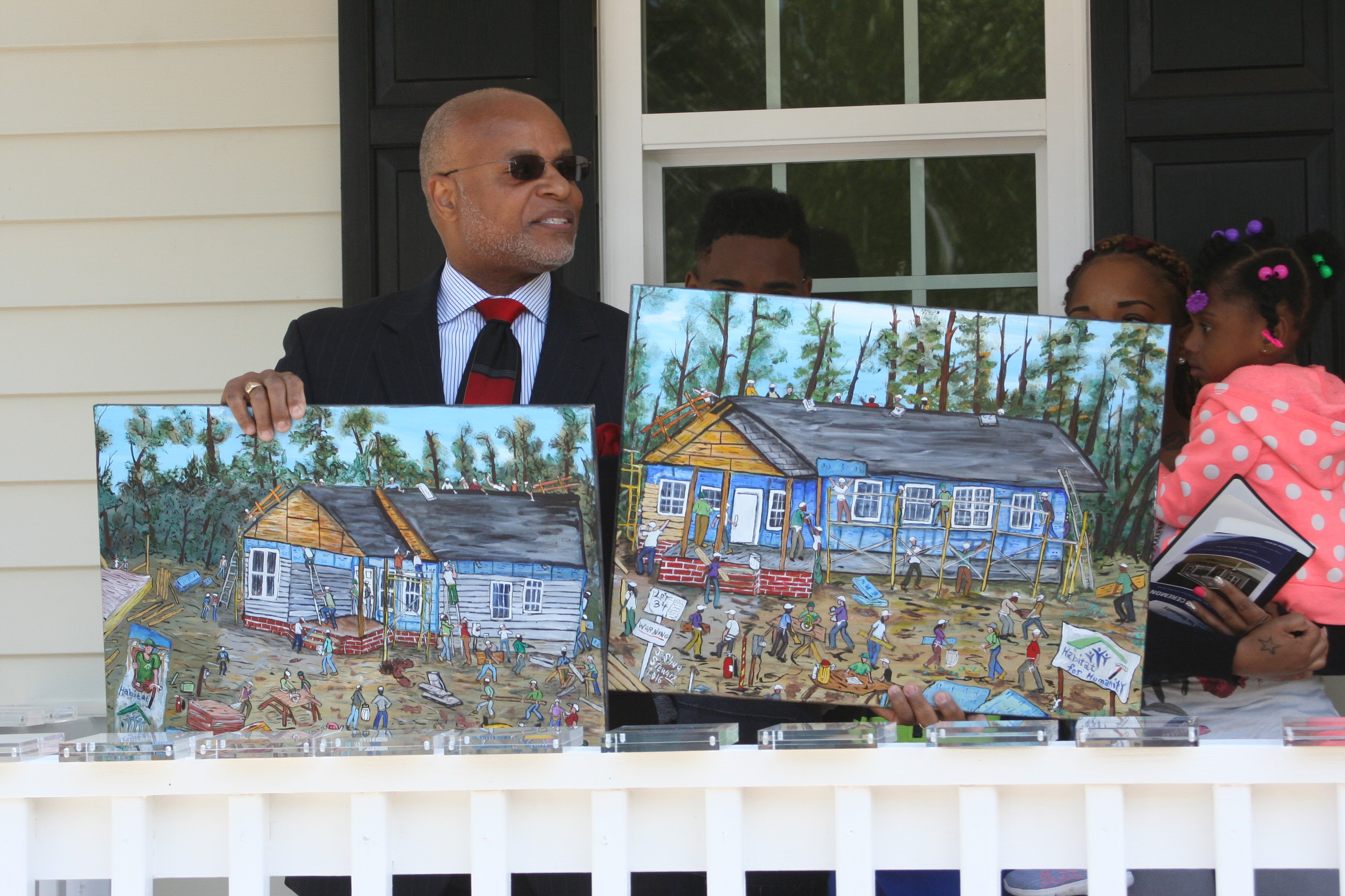 Rev. Anderson showing off two beautiful canvases.