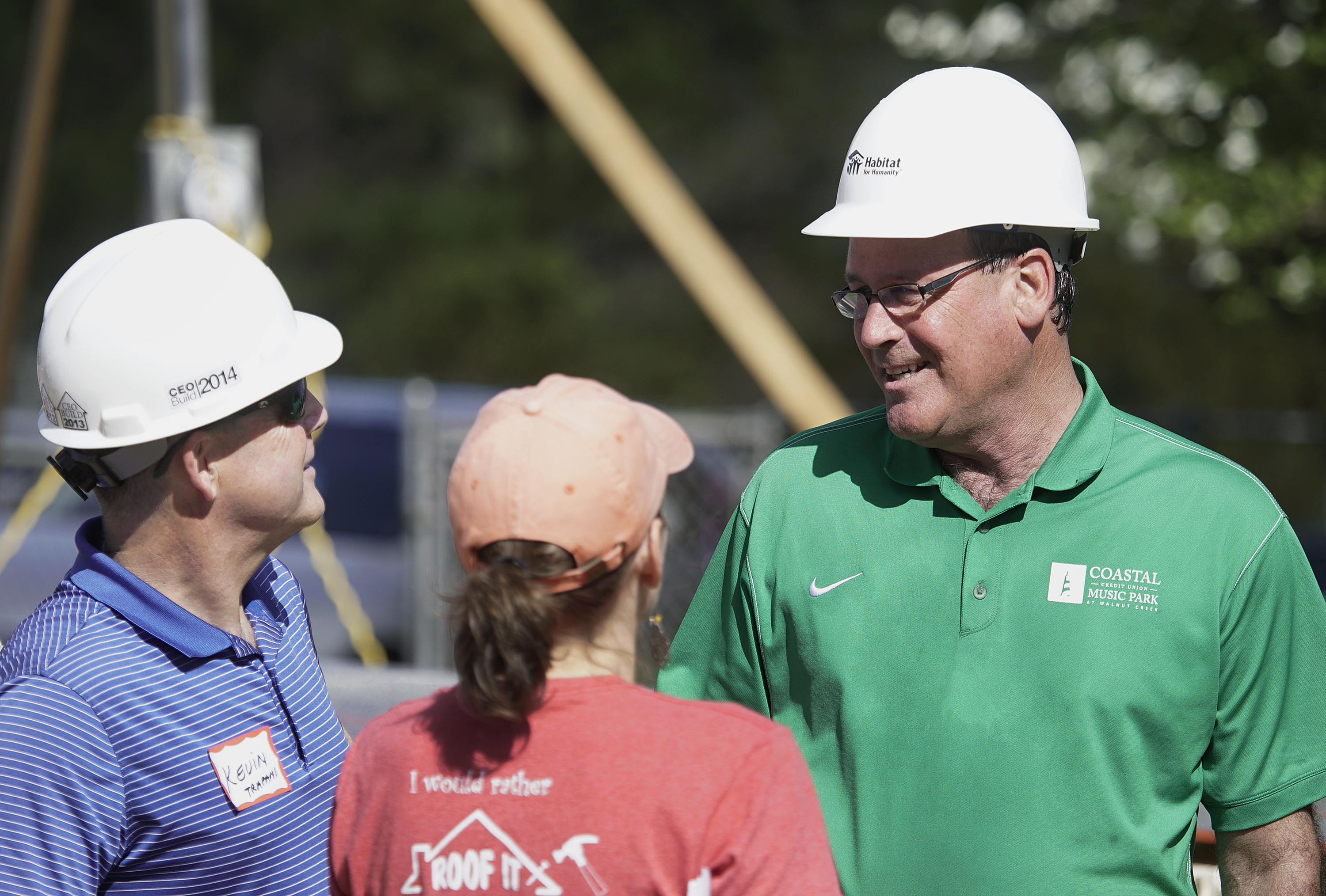 Man in hardhat talking to others