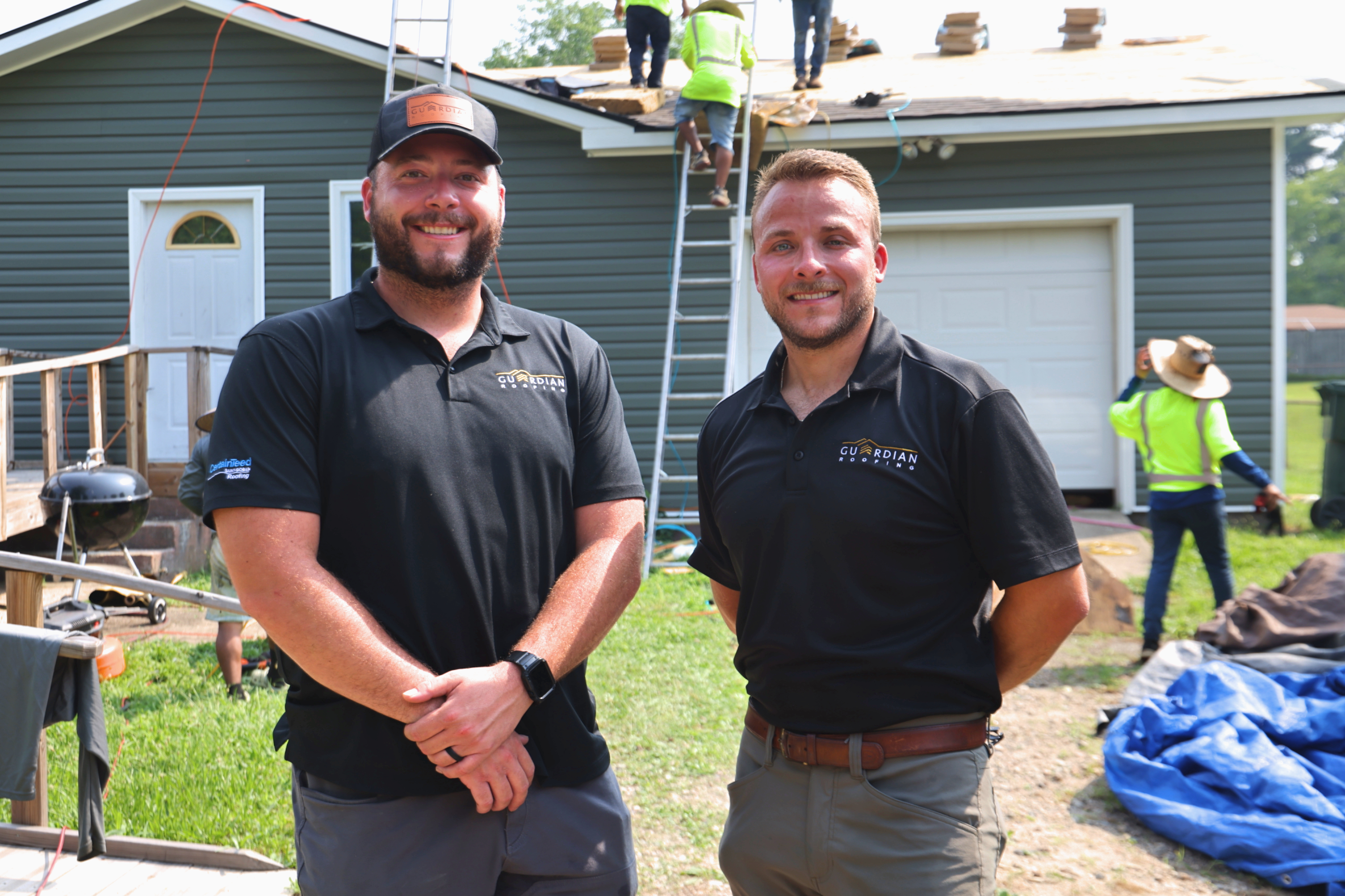 Co-owners of Guardian Roofing stand outside of the repair site