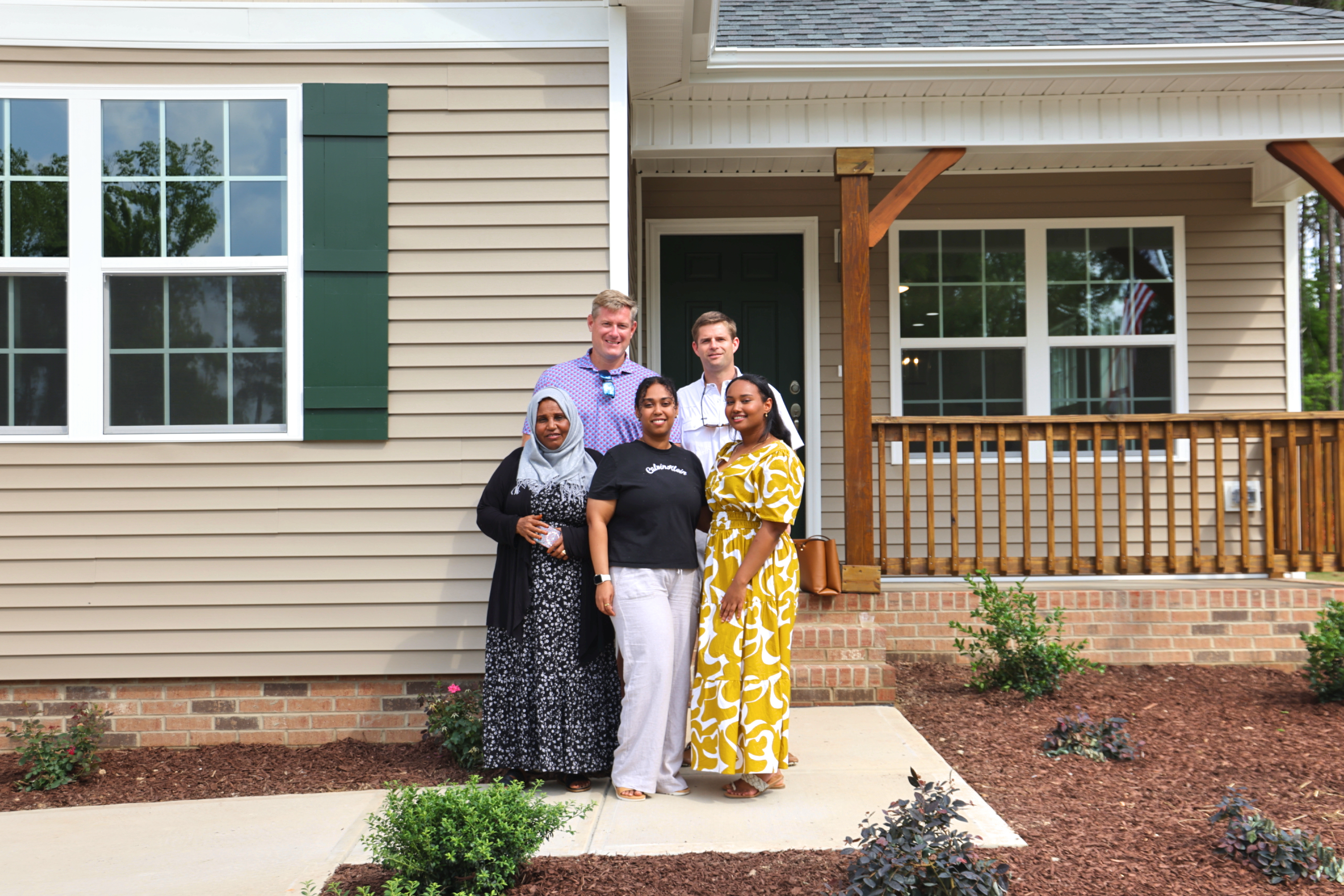 homeowner Marwa and family pose outside home with Upton & Co and Triplr A Homes