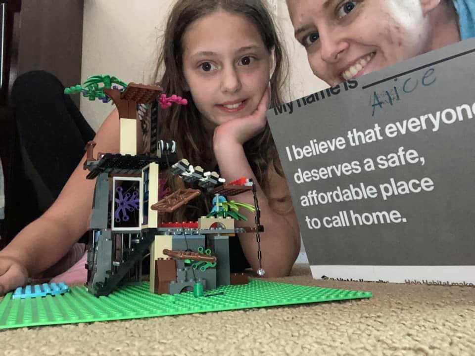 A child builds a house from Legos