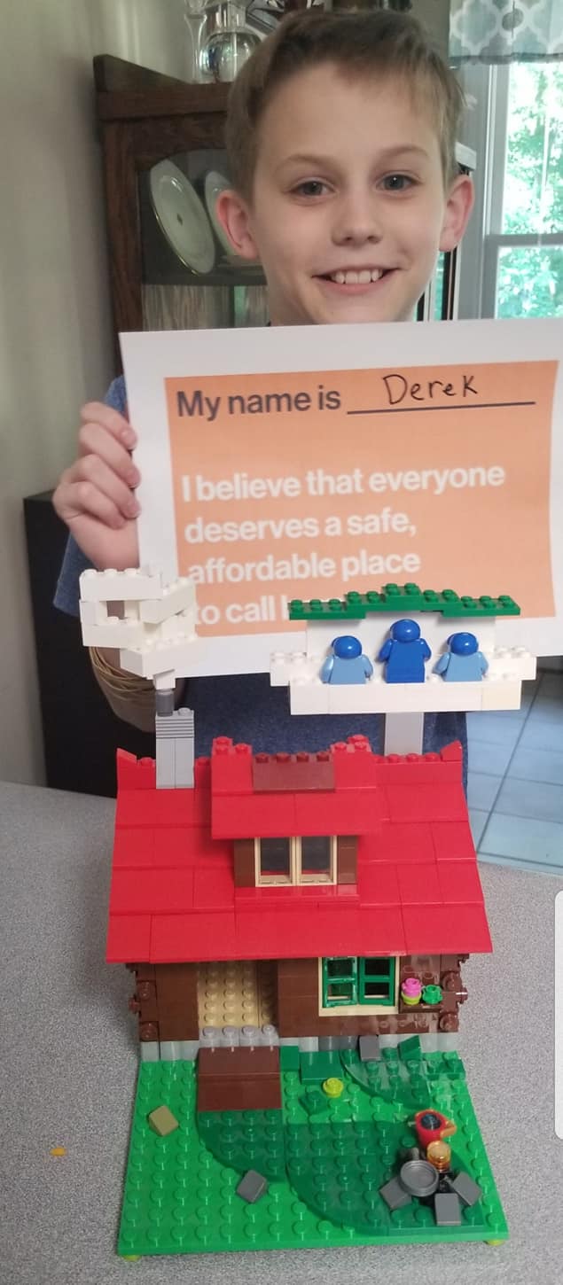 A child builds a house from Legos