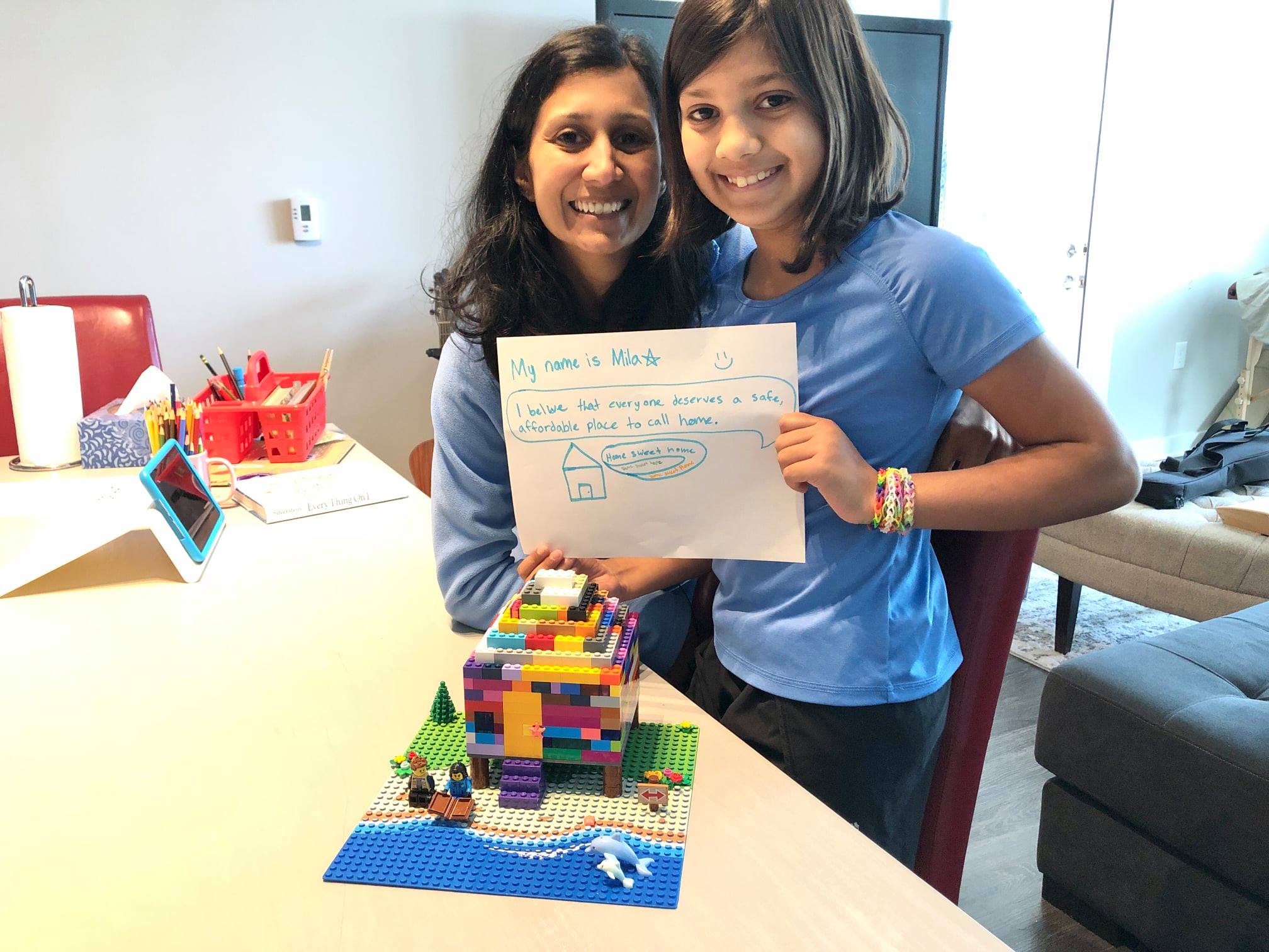 A child builds a house from Legos