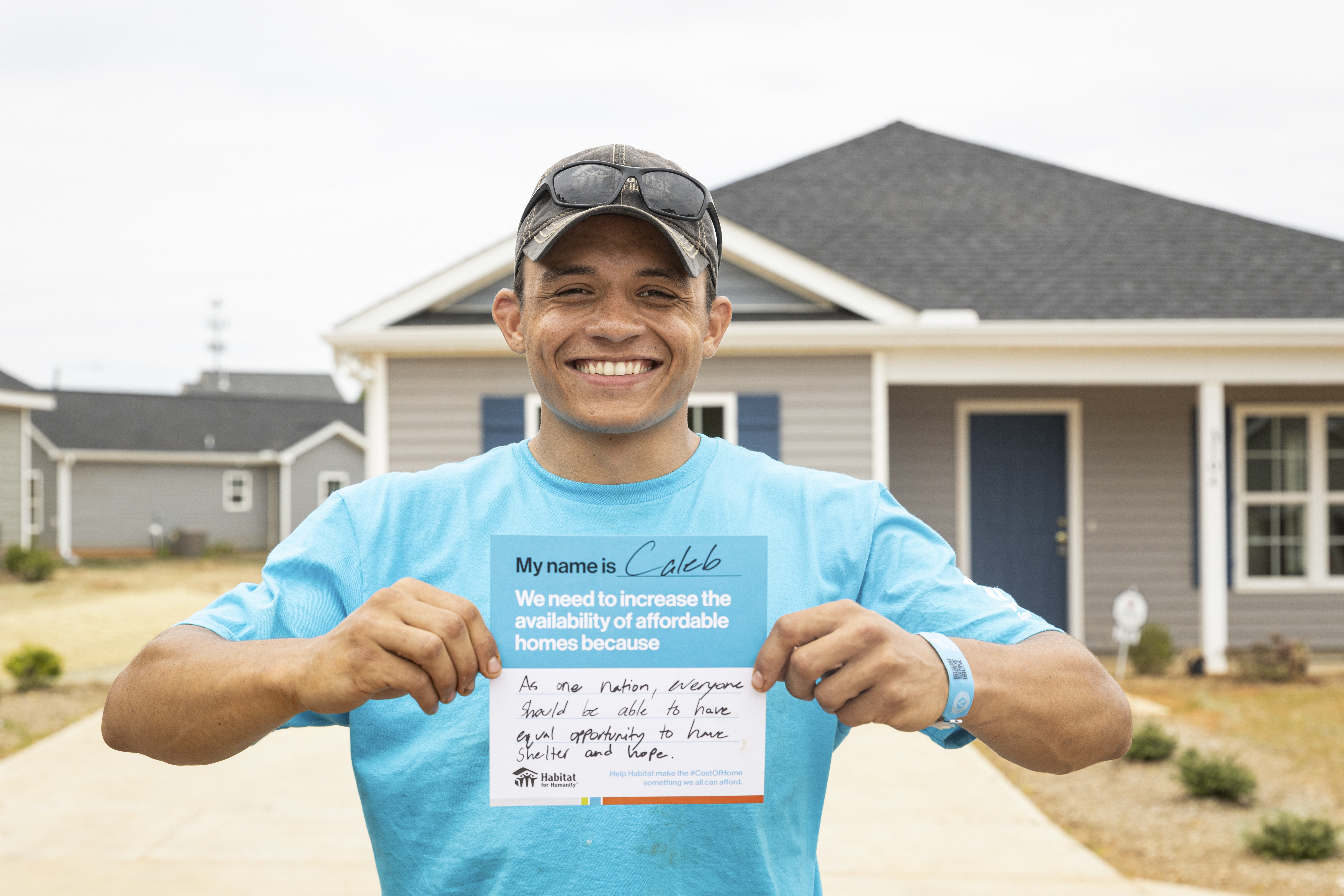 Man holding sign saying that housing is a human right