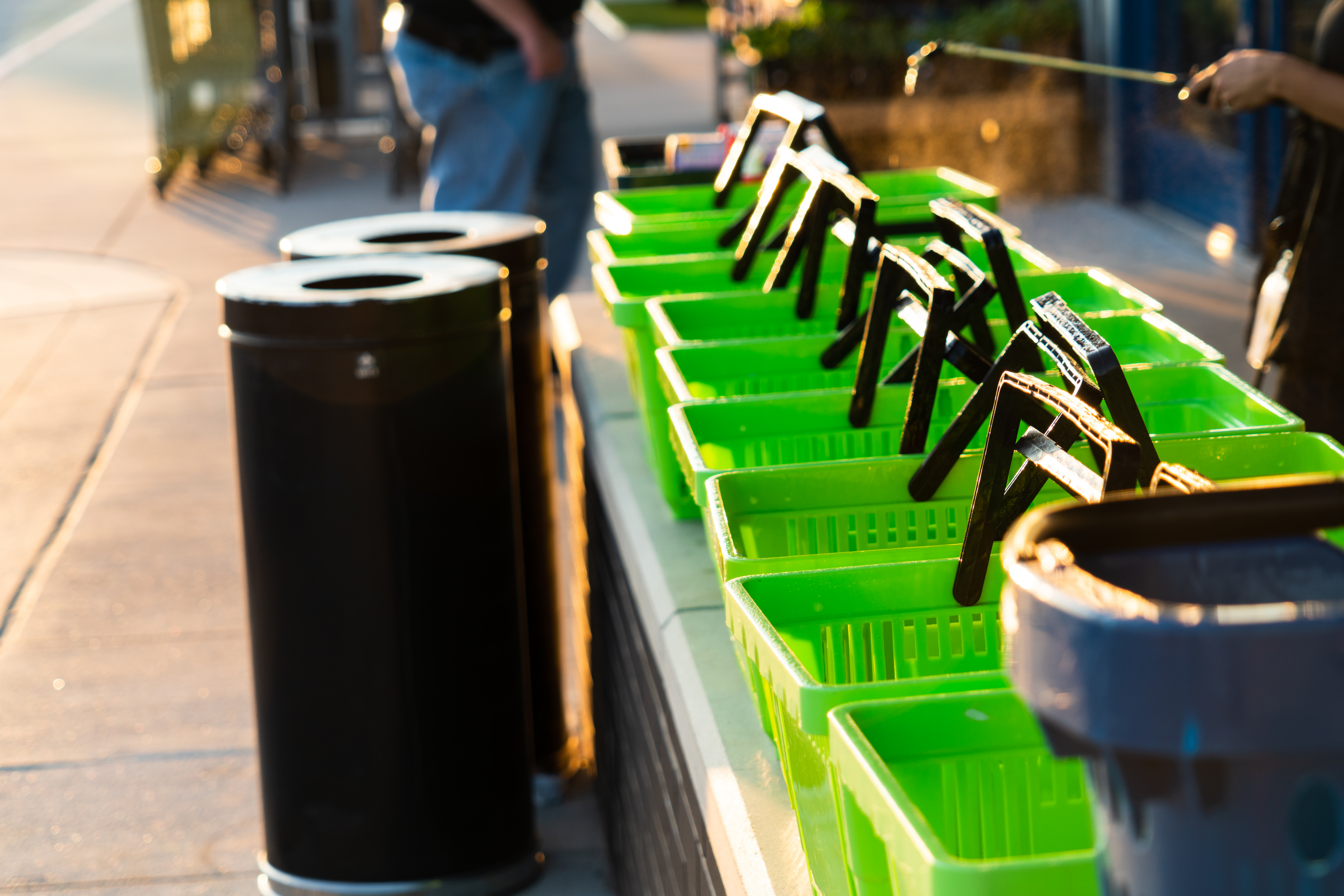 A person cleaning shopping carts. Essential workers do not have the option to work from home.