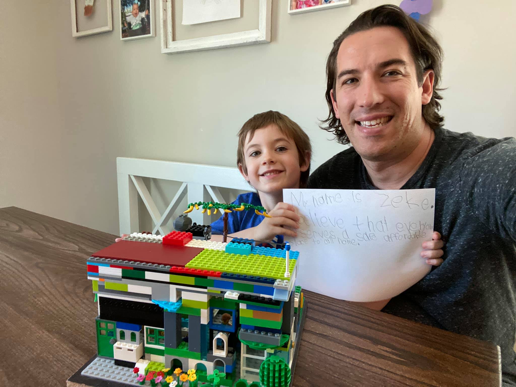 A child builds a house from Legos