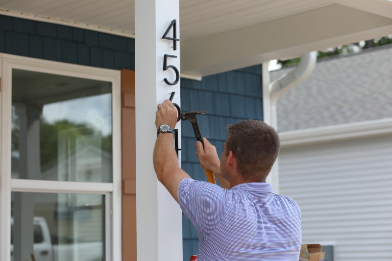 House numbers get nailed onto a new Habitat Wake home