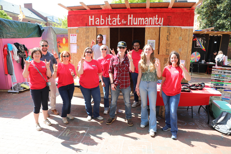 habitat wake staff and habitat for humanity campus chapter at nc state posing in front of habitat shack on wolf plaza