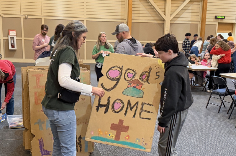 members of St. Francis hold baffle painted at Habitat faith night