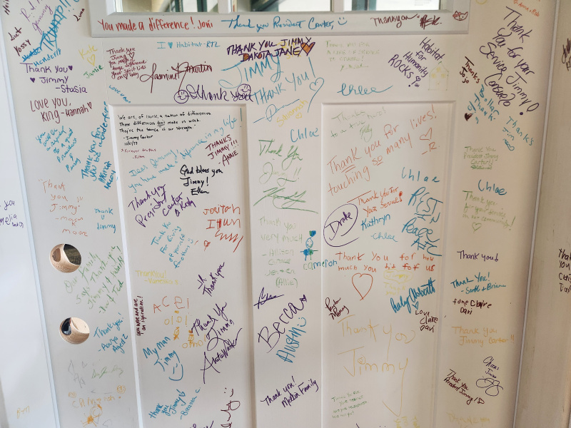 Jimmy Carter Legacy door full of colorful signatures and messages from the community