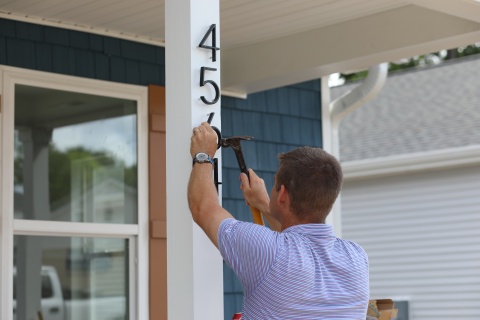 House numbers get nailed onto a new Habitat Wake home