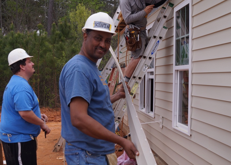 A Habitat homeowner working on his house 